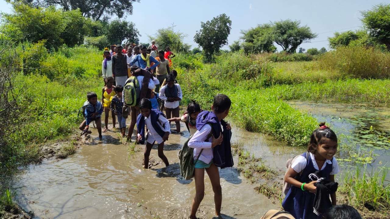 Villagers living among problems due to lack of basic facilities, school children crossing the river