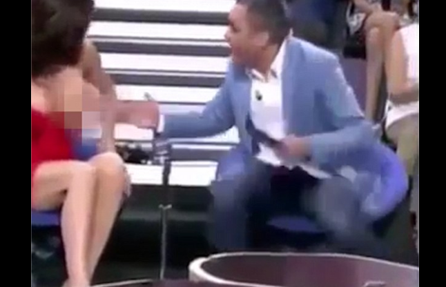 presenter pulls down Woman top