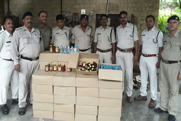 Excise staff with seized liquor