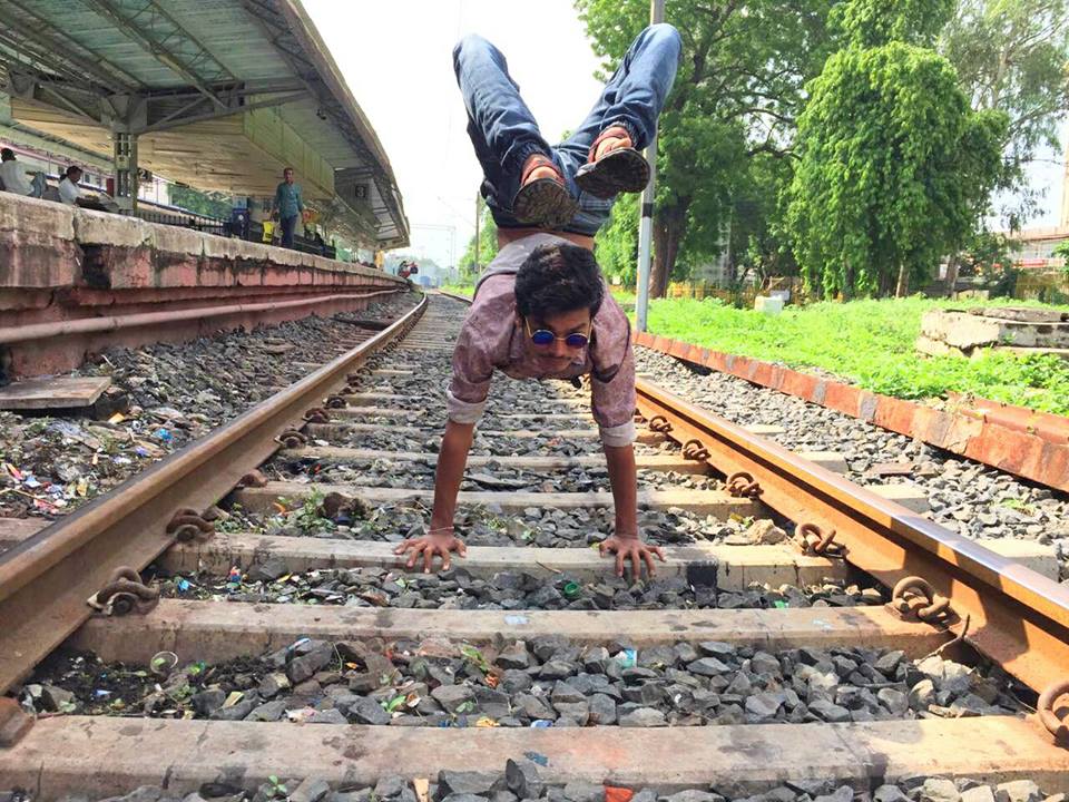 people taking risk and taking selfies on railway track