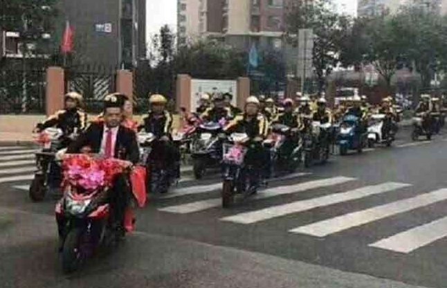 couple married on scooter