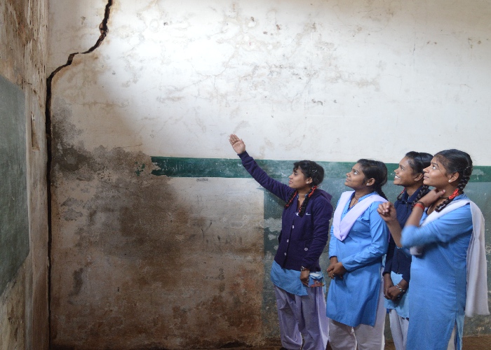 Girl students studying in a shabby school