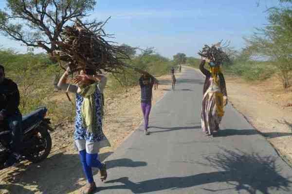 Whole family carrying fuel
