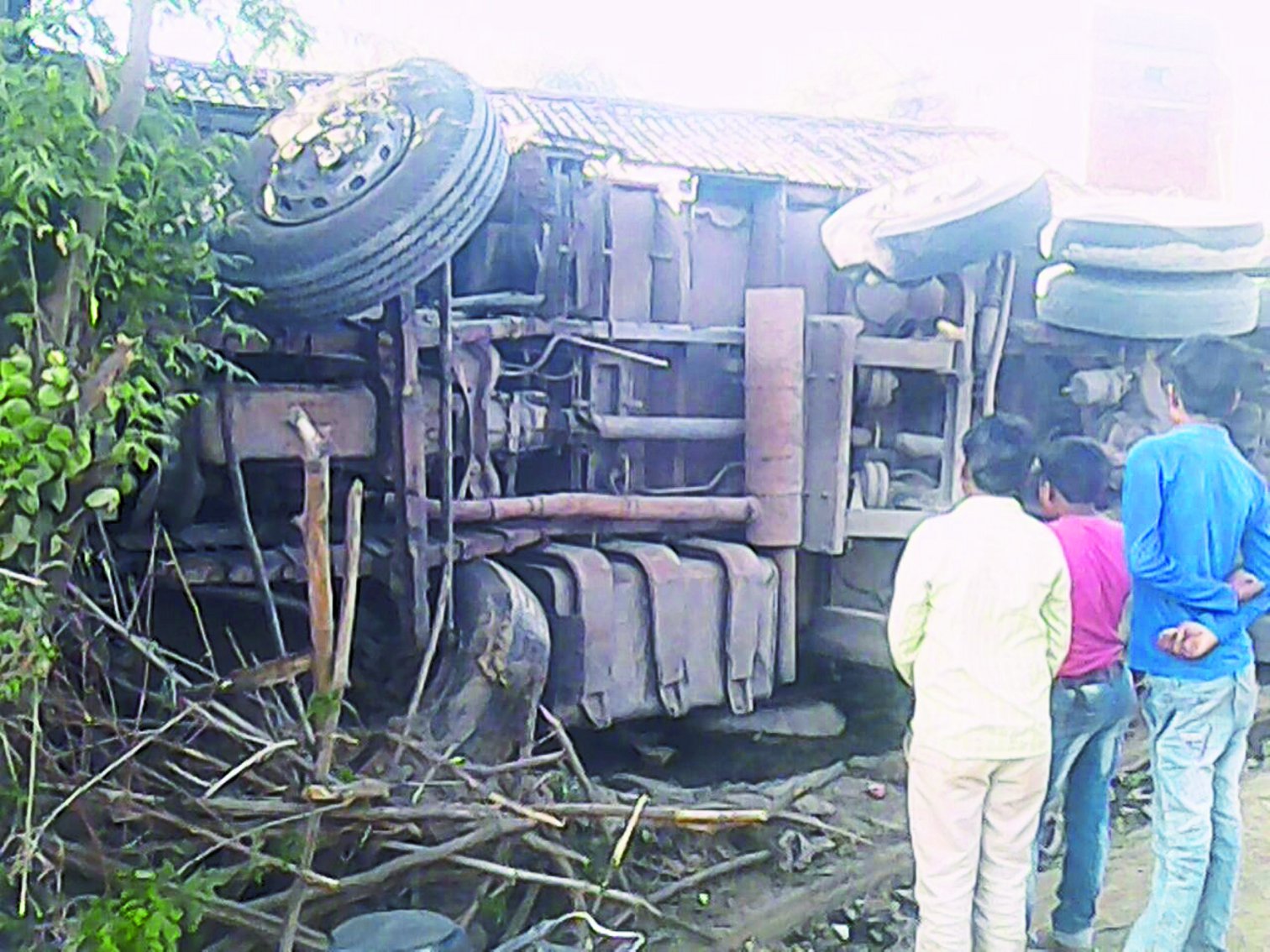 Three people aboard bike collided with truck collision