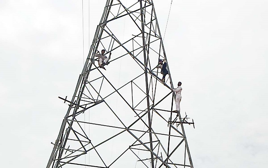 Three young man climbed on electric towers