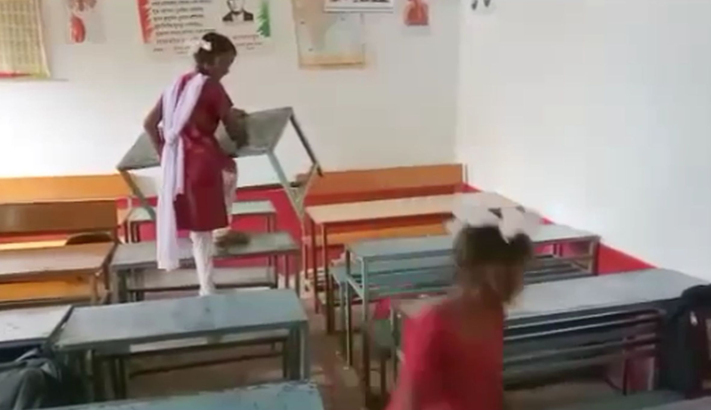 At the school's PUN AC office, the girl adopts the broom