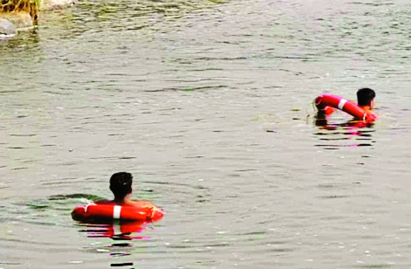 Two youths immersed in Tapi river