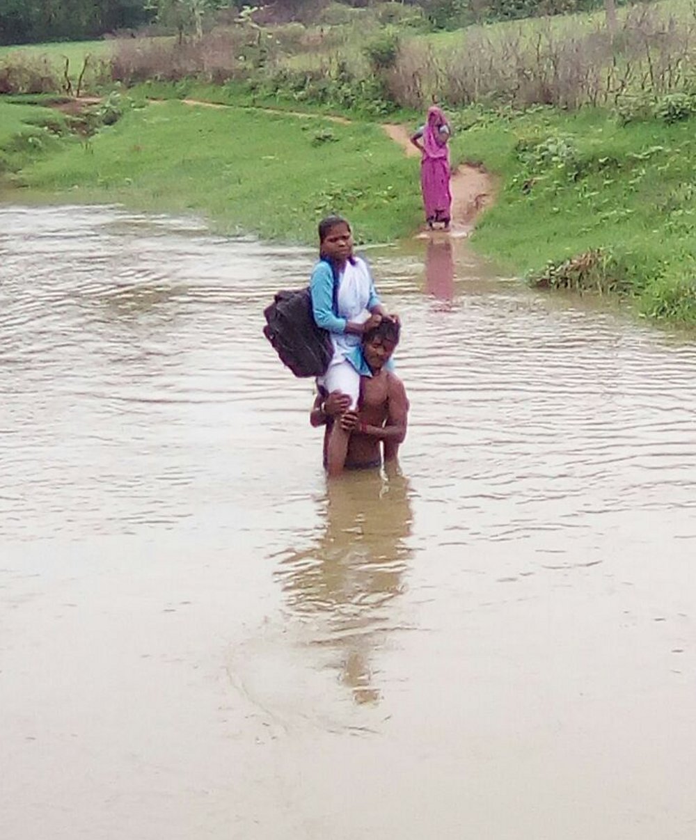 Student have to cross river on brother shoulder in Panna District