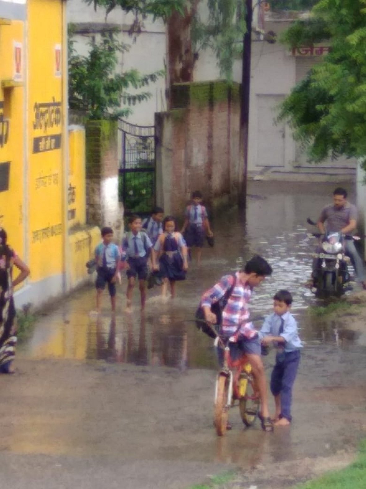 Children crossing water in colony school