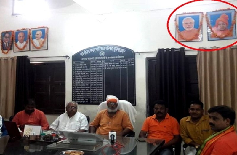 garland on photos of narendra modi and yogi adityanath