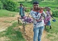 Women and newborn on cot