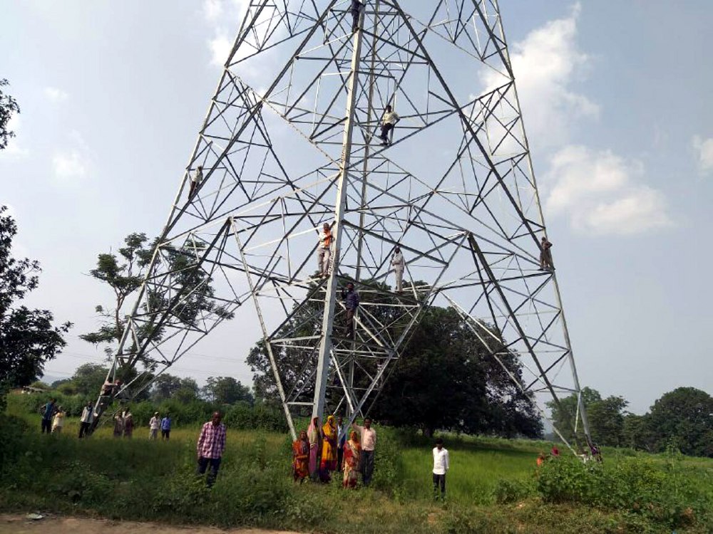 three farmers climbs on the electric tower since three days