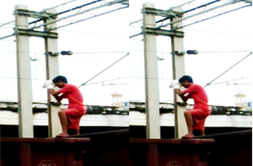 man climb on train touch current wire