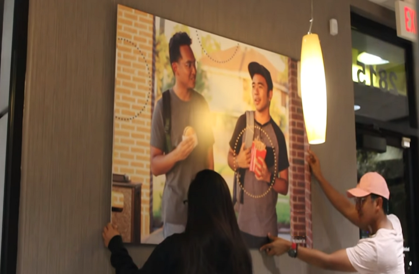 asian youtuber walked into a food outlet and hung his own poster