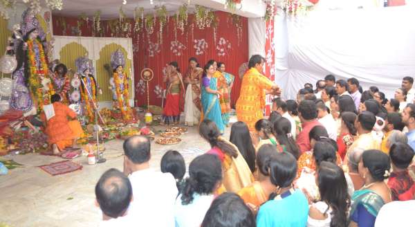 People of Bengali society worshiping Durga Ashtami in indoor stadium