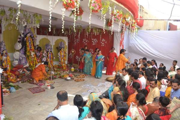 People of Bengali society worshiping Durga Ashtami in indoor stadium