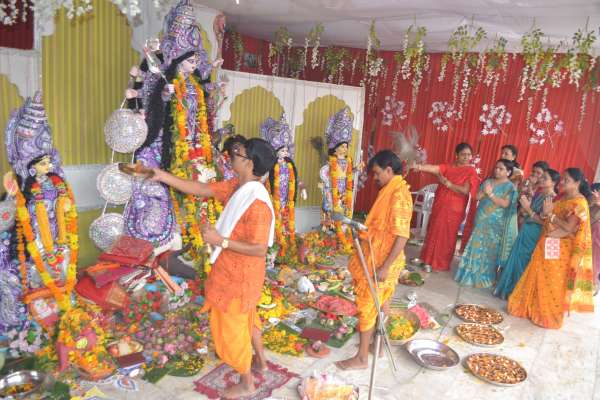 People of Bengali society worshiping Durga Ashtami in indoor stadium