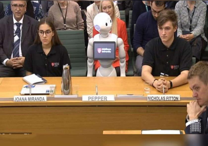 Robot presented report in UK parliament theresa may trolled