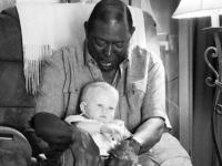 this picture of black man holding white baby is breaking internet