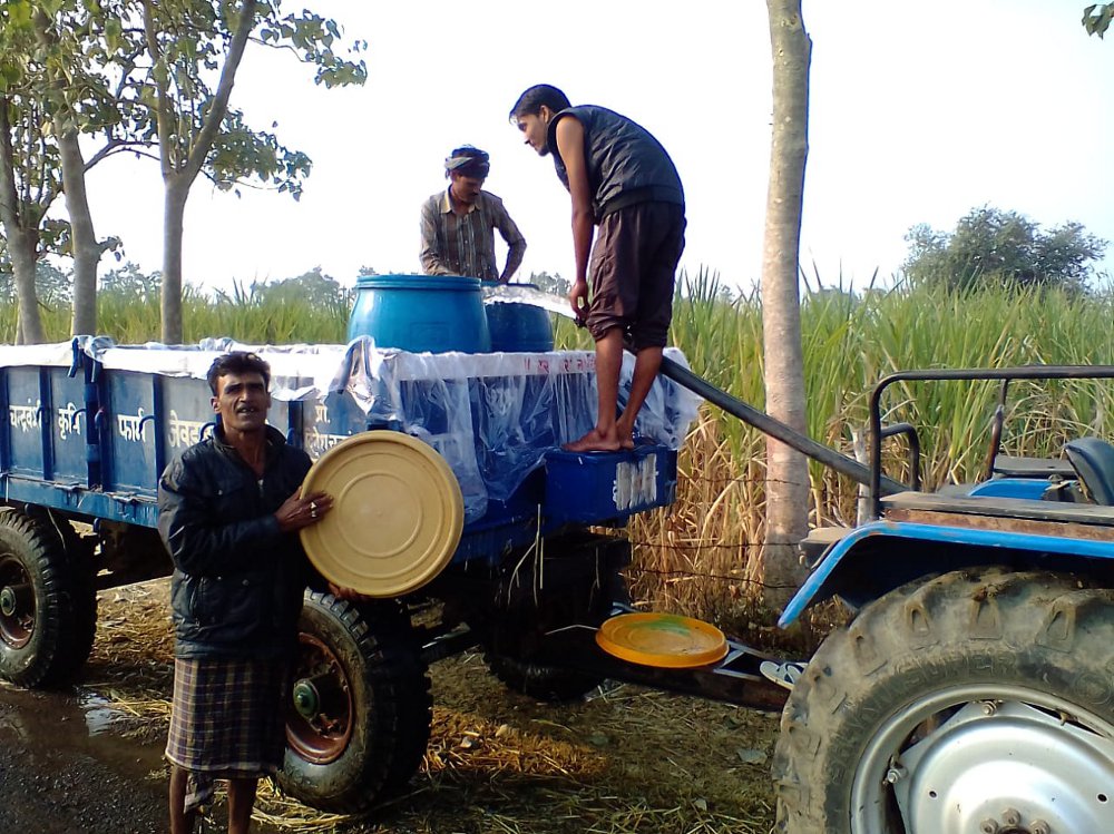 Taking water to drink in the tractor
