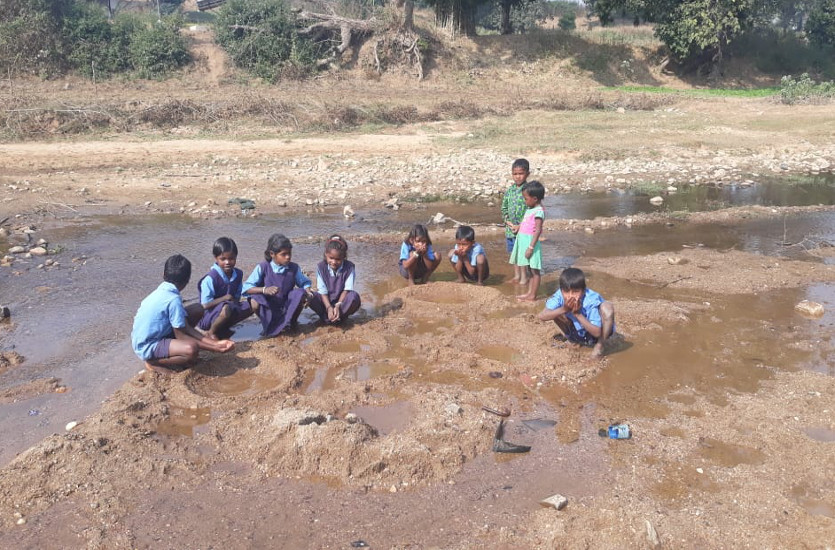 School student drinking river water