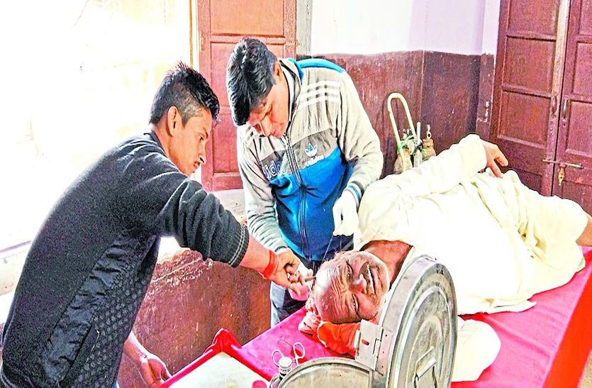 घायल का उपचार करते चिकित्सा कर्मी।
