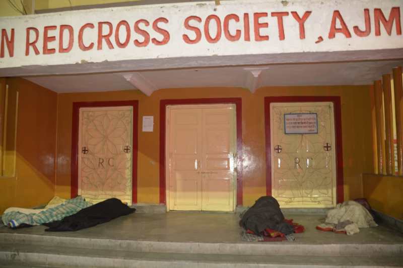 People sleeping on blanket, dump, blankets near the circle