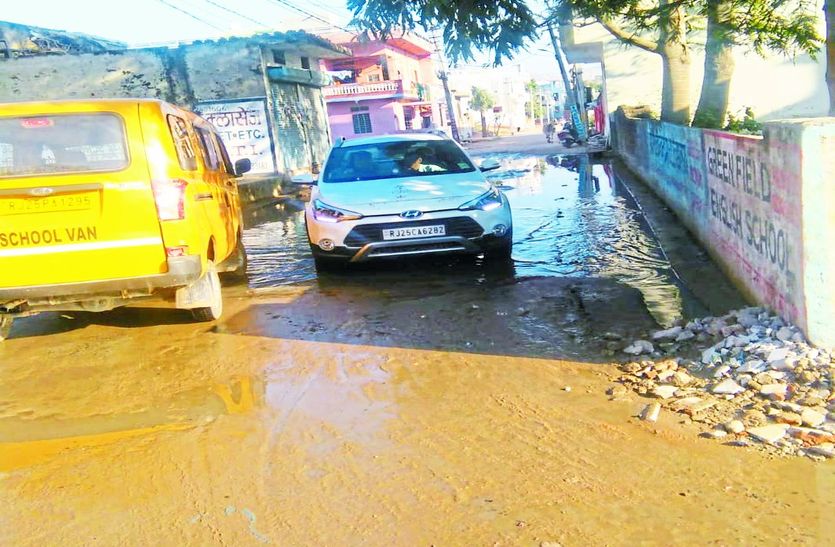 कीचड़ भरे रास्ते से निकलते वाहन।