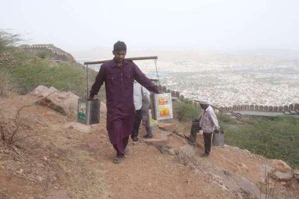 pics of People carrying water on the shoulders