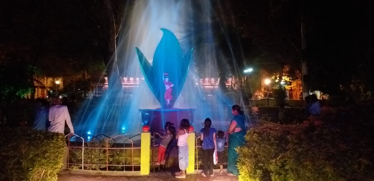 Here people who are reaching fountains between color changing lights