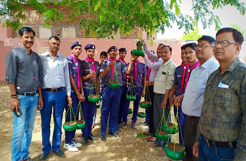 परिंडे बांधते लोग।
