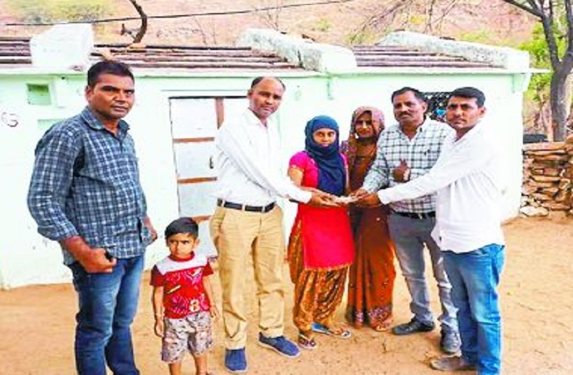 राशि सौंपते हुए।