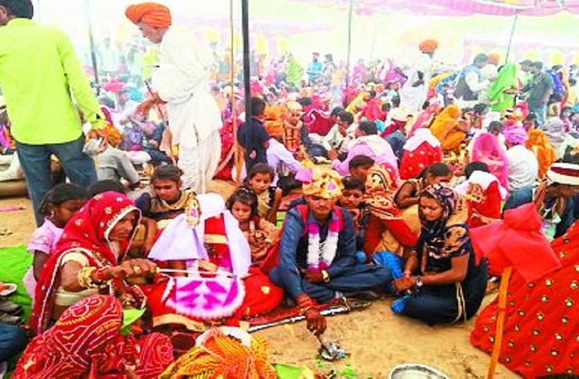 विवाह सम्मेलन में परिणय सूत्र में बंधते हुए नवदम्पती।