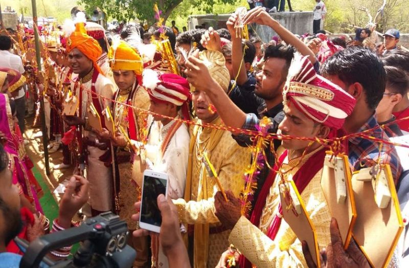 31 couples tied together in conjunction formula at the Mass Marriage