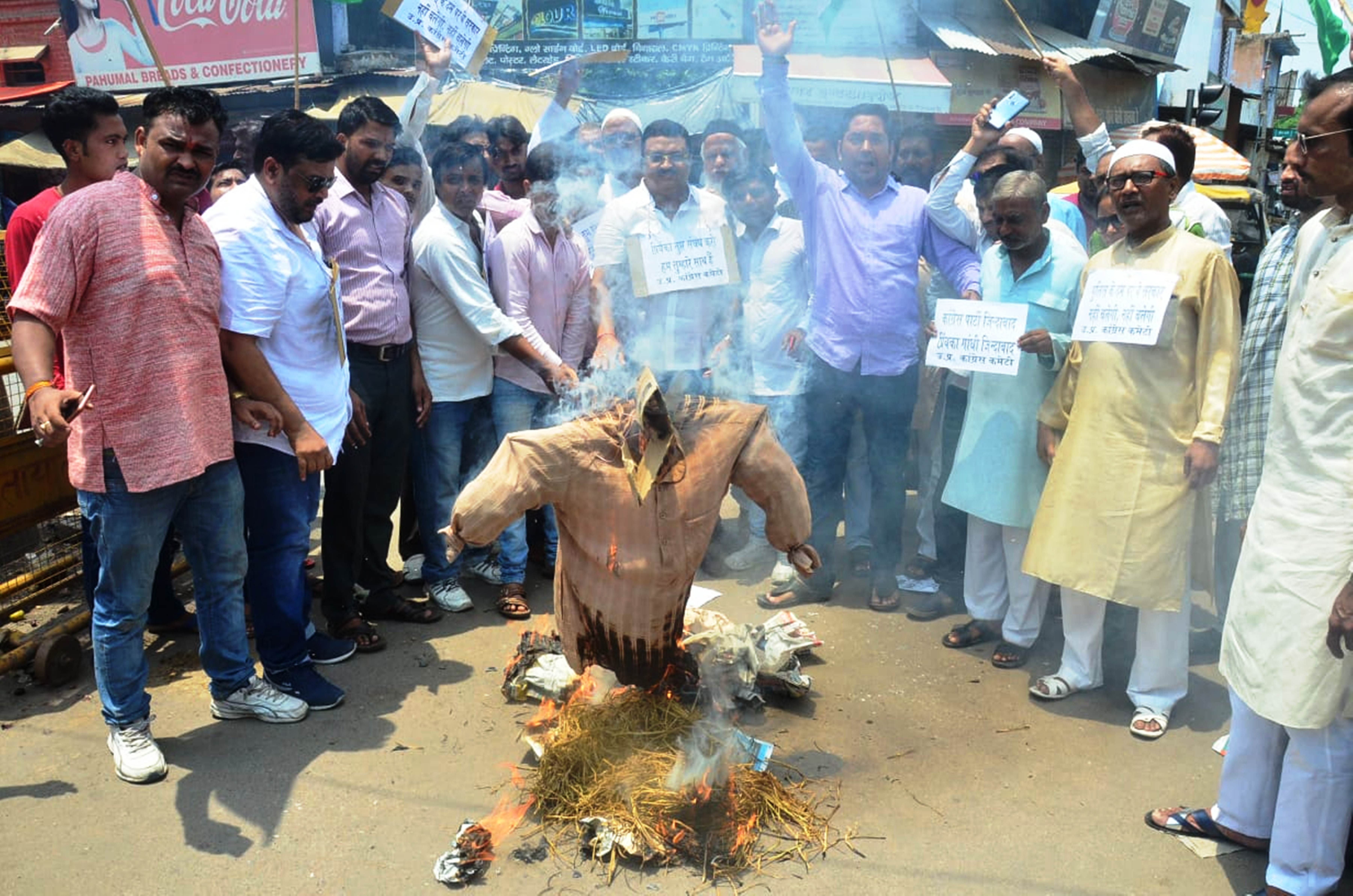 congress workers blow the effigy of up cm yogi adityanath