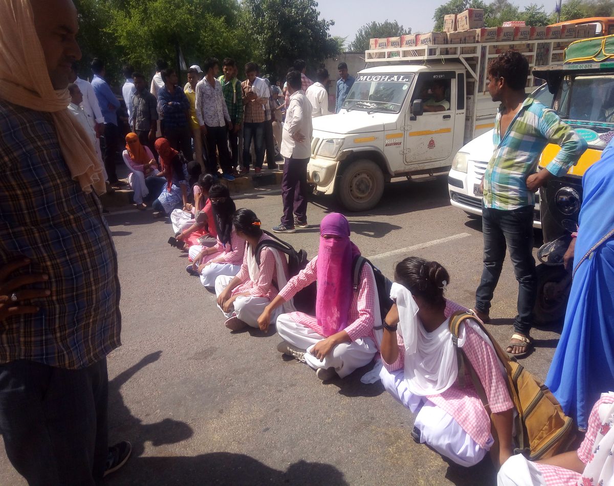 Girl students protest by blocking the road