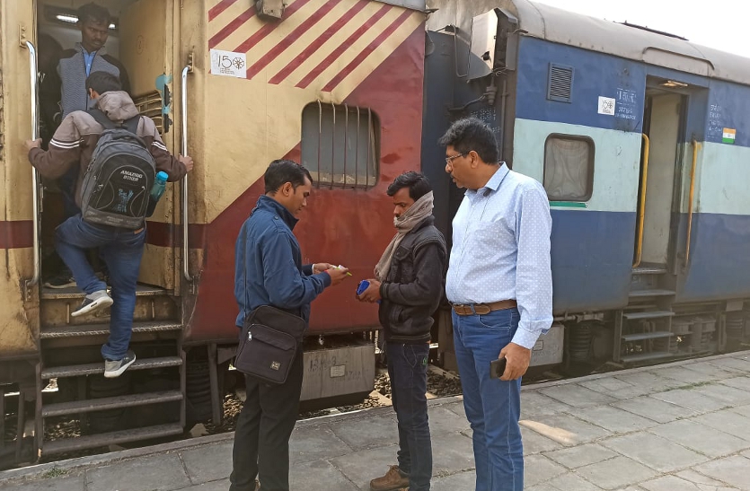 Railway officials interrogating passengers