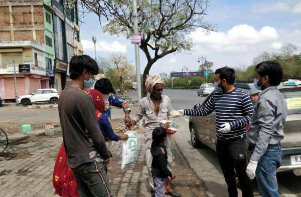 लॉक डाउन के बीच जरूरतमंदों को भोजन करवाते एक संस्था के लोग