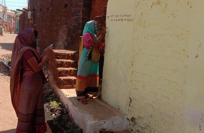 Asha workers write slogans in the wall