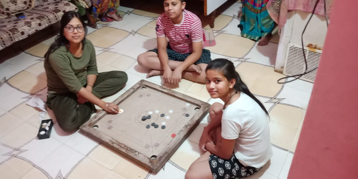Ludo, children spending time playing carrom