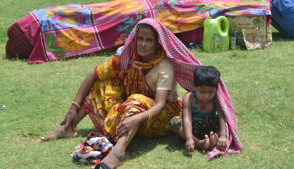 धूप में परेशान होते प्रवासी श्रमिक