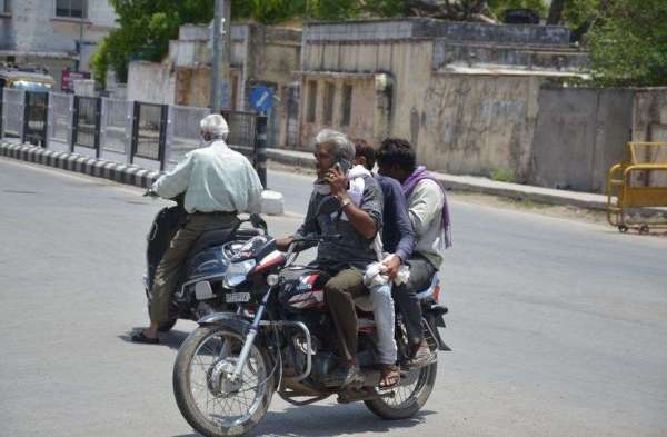 चित्तौडग़ढ़ में बिना मास्क लगाए बाइक सवार व्यक्ति।