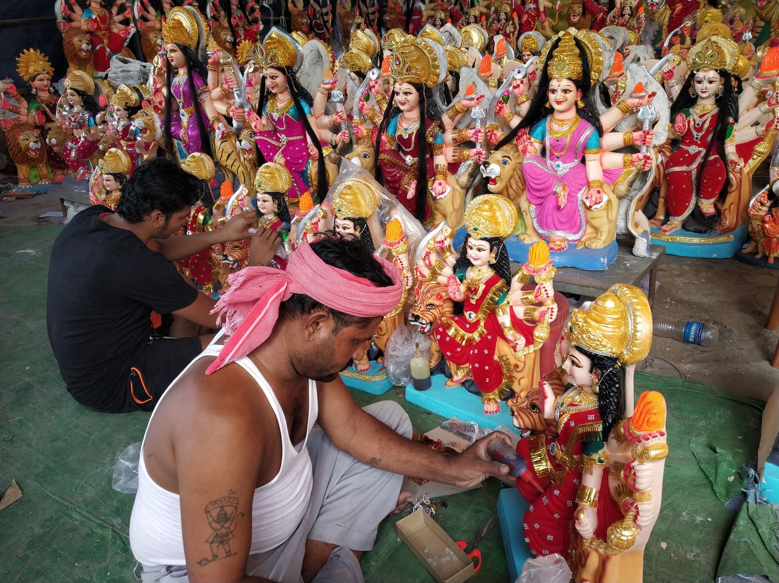 Sculptor engaged in finalizing Maa Durga idols