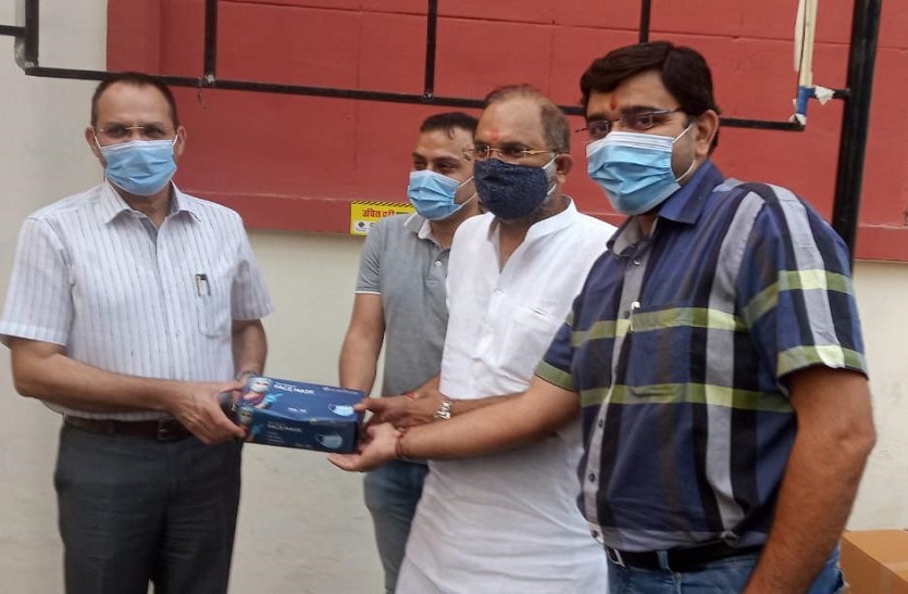 Rotary club president handed over mask, sticker to collector