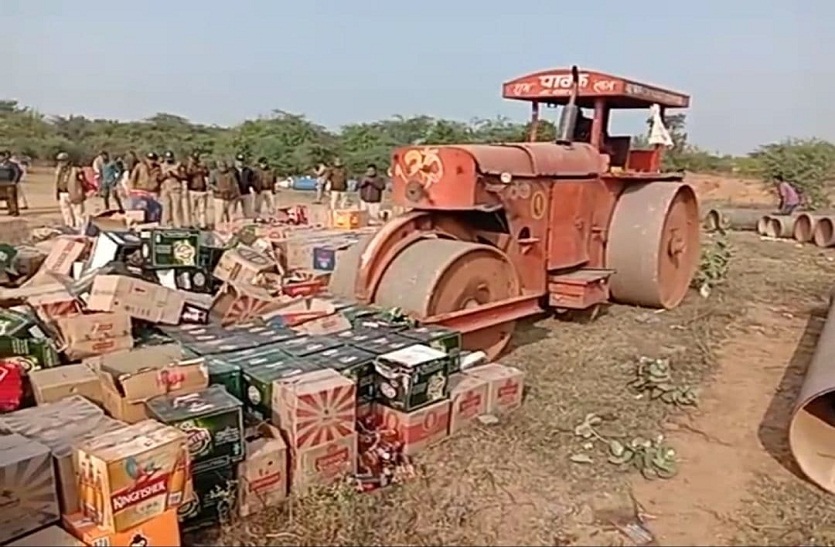Bulldozers crushed liquor bottles in the open ground