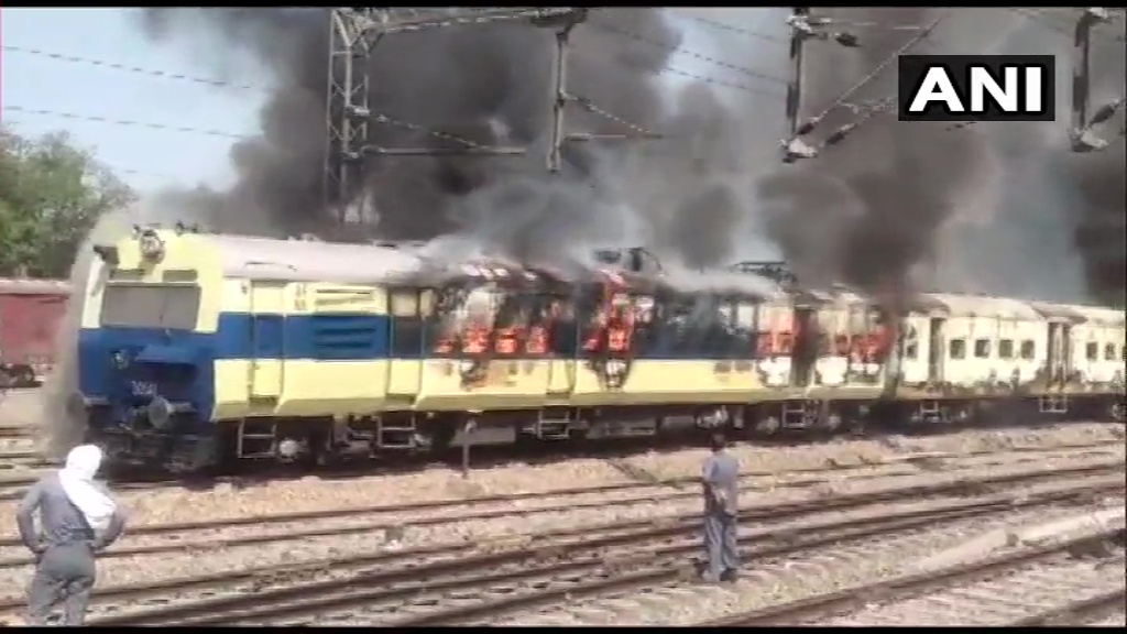 Four couches of train under fire, parked at Rohtak Railway Station in Haryana 
