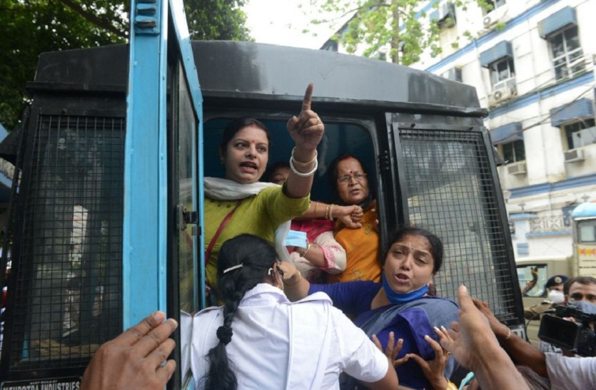 दक्षिण कोलकाता में भाजपा समर्थक प्रदर्शनकारियों को गिरफ्तार कर पुलिस वैन में ले जाते पुलिसकर्मी। 