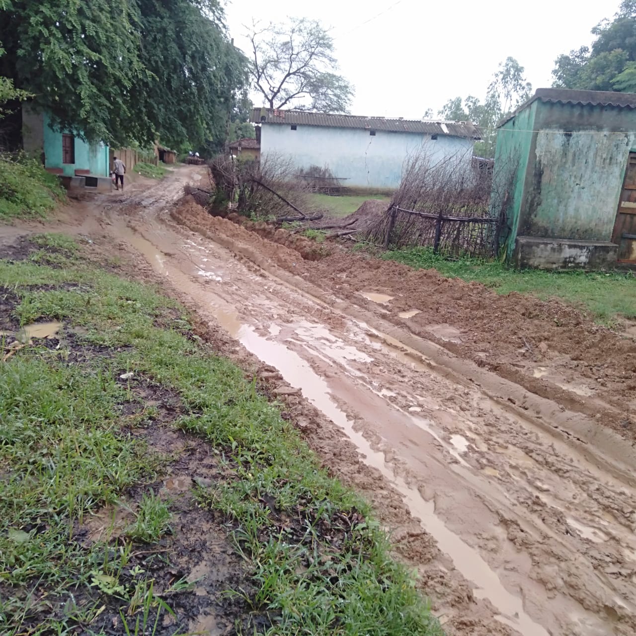A pit dug laying pipeline, a swampy road made in rain water