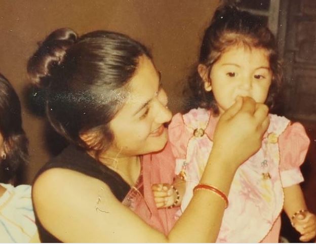 This baby girl seen in mother's lap is a Bollywood superstar