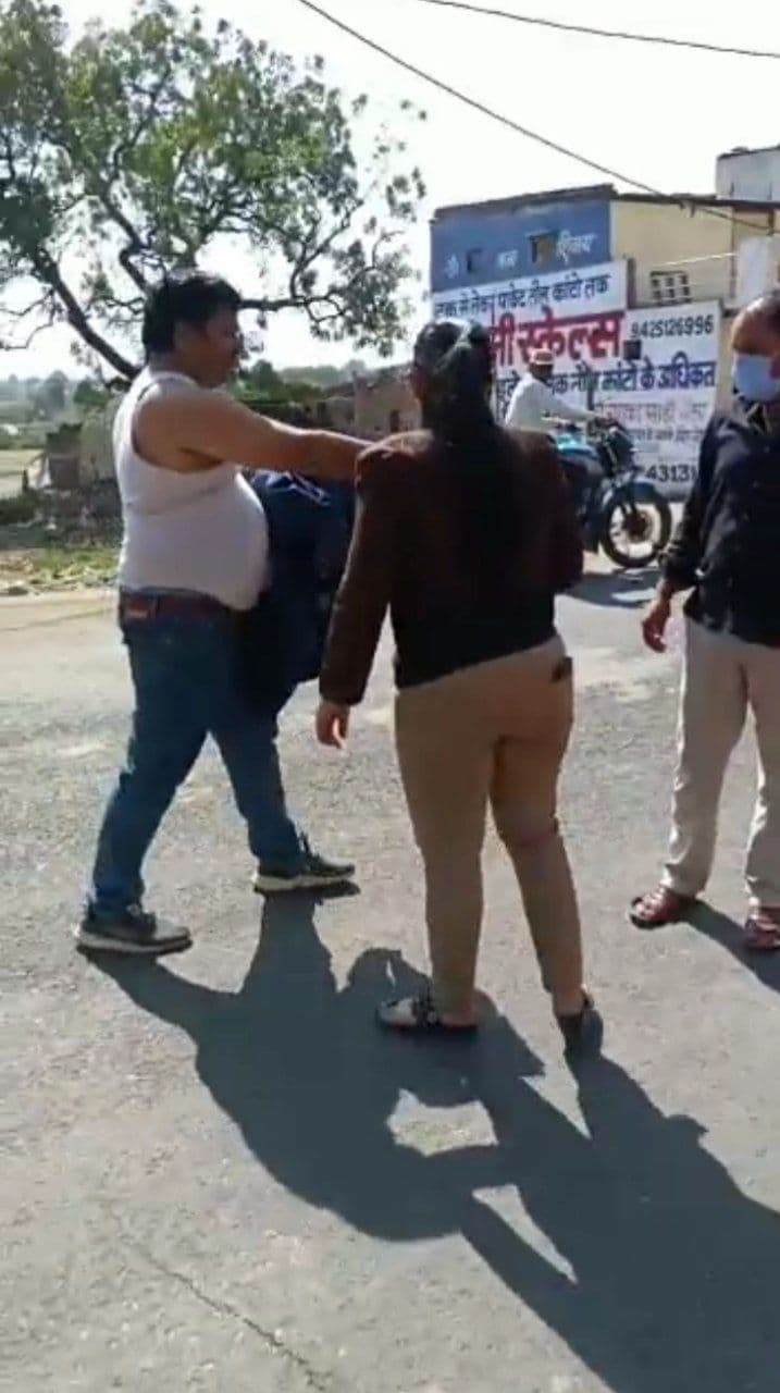 Young man lying on the road after taking off his clothes